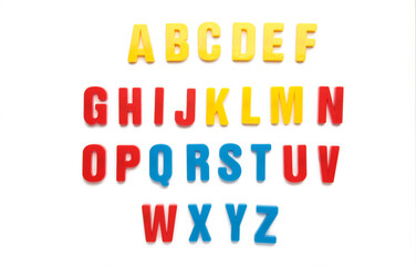 Magnetic plastic alphabet letters isolated on white background.