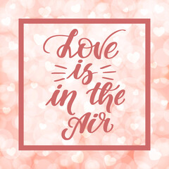 Love is in the air. Handwritten lettering on blurred bokeh background with hearts. illustration for posters, cards and much more