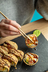 person is going to eat roles. Japanese cuisine
