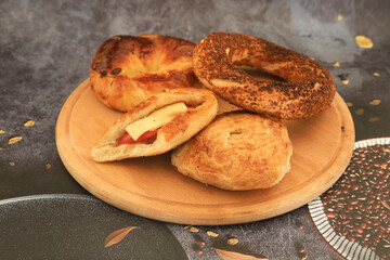 On a wooden base , tomato and cheese pastry , simit , and its Turkish name : opening