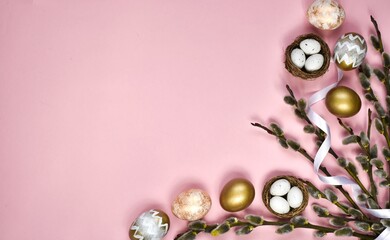 Flat lay Easter composition with willow branches, nest and eggs, white ribbon on a pink background. Happy easter postcard. Top view with copy space