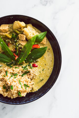 vegan green curry with tofu bell pepper and cauliflower served with brown rice, healthy plant-based food