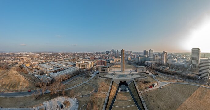 Drone panorama of World War II memorial with Kansas City skyline during sunrise