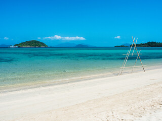 Scenic white sand beach tropical paradise island with crystal clear turquoise sea water and coral reef against blue sky in summer. Koh Mak Island, Trat, Thailand.