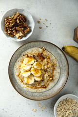 Healthy oatmeal porridge with banana and walnut