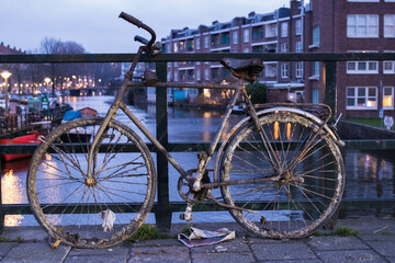 Fototapeta na wymiar Old bike over the river selective focus