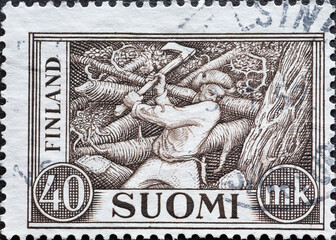 Finland - circa 1930: a postage stamp from Finland, showing a wood cutter felling trees with an axe
