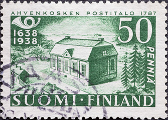 Finland - circa 1938: a postage stamp from Finland, showing a historical building in the forest Post Office Ahvenkoski (1787)