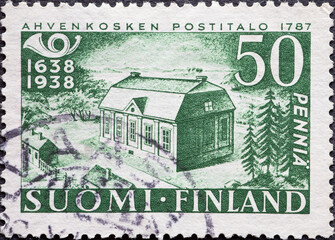 Finland - circa 1938: a postage stamp from Finland, showing a historical building in the forest...