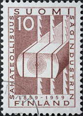Finland - circa 1959: a postage stamp from Finland, showing a Stylized Tree Trunk with Sawing Blades