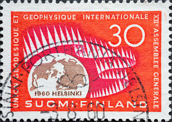 Finland - circa 1960: a postage stamp from Finland, showing Globe & Presentation of Northern Lights. Geodetical-Geophysical Congress