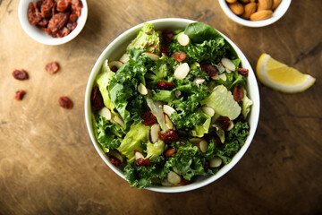 Healthy kale salad with cranberry and almond - obrazy, fototapety, plakaty