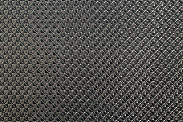 Close up of gray synthetic textured fabric with a rhombus pattern. Template design or polyester material abstract background.