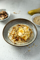 Fototapeta na wymiar Healthy oatmeal porridge with banana and walnut