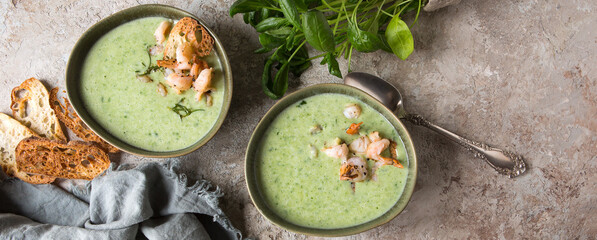 Fototapeta na wymiar bowls of cream soup with spinach and shrimp on the table