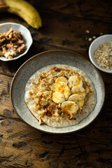 Healthy oatmeal porridge with banana and walnut