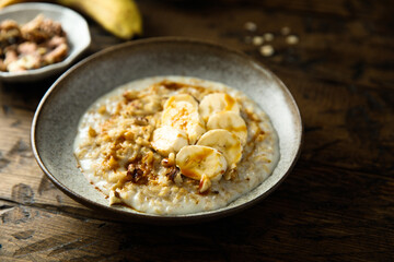 Healthy oatmeal porridge with banana and walnut