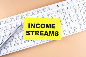 Text INCOME STREAMS text on a sticky on keyboard, business concept