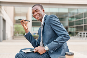 young african-american businessman sending a voice message with his smart phone
