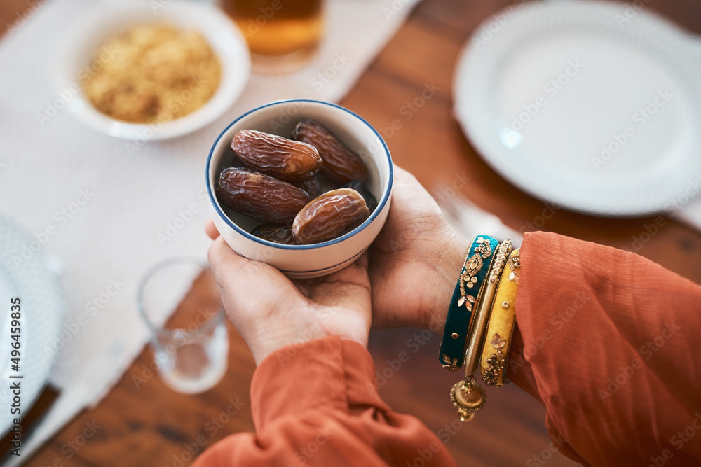 Wall mural breaking my fast the traditional way. shot of a muslim woman holding a bowl of dates to break her fa