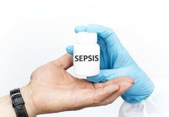 Sepsis text on the label of the white can, which is given by the doctor to the patient, a close-up of the hands on a white background. Medical concept.