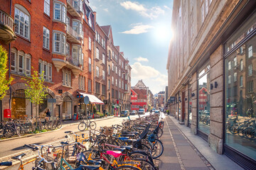 Many parked bikes on a narrow old Minter Street Møntergade in the Old Town of Copenhagen, Denmark - obrazy, fototapety, plakaty