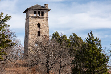Fototapeta na wymiar The abandoned water tower rises above the barren trees of fall in Ha Ha Tonka State Park, Missouri 