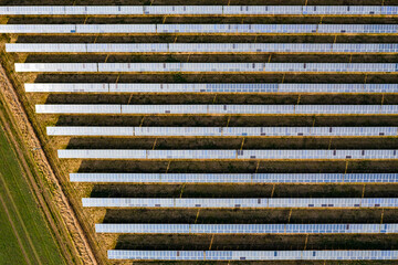 Luftaufnahme einer Vielzahl Module einer Photovoltaik-Anlage auf einer Solarfarm im ländlichen...