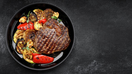 Grilled steak with baked vegetables and mushrooms