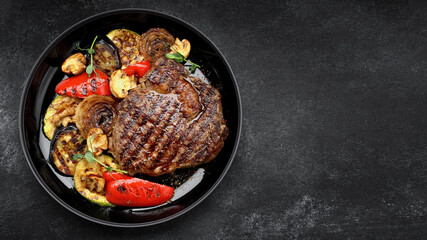 Grilled steak with baked vegetables and mushrooms