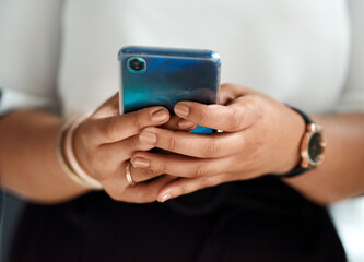 I have a contact that could help me with business matters. Closeup shot of an unrecognisable businesswoman using a cellphone in an office.
