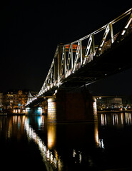 The iron bridge ("eiserner Steg") over the Main in Frankfurt at night and illuminated.
