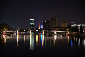 Night view on a part of the skyline in Frankfurt am Main with reflections in the river