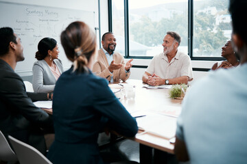 I must say Im very pleased with our work. Shot of a group of businesspeople listening to a...