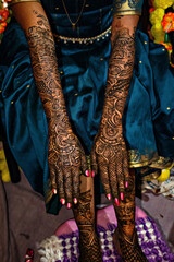 Stock photo of beautiful Indian bridal showing her henna hands, applied on the occasion of wedding at Kolhapur, Maharashtra, India. Henna symbolizes positive spirit and good luck for bride and groom.