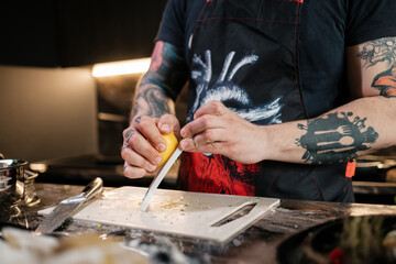 The cook peels the lemon zest. The concept of making juicy sauce.