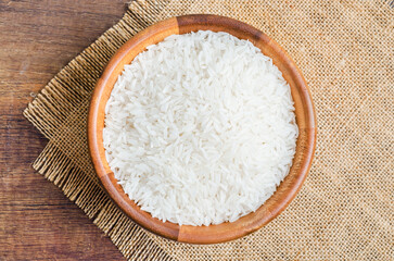 Organic Thai Jasmine rice grain in wooden bowl preparing for cooked