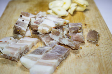 Salted bacon cut into pieces with garlic