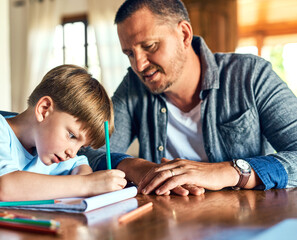 Dads on standby to help with homework. Shot of a father helping his son with his homework.