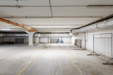 Empty underground parking with bicycle in basement