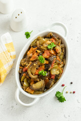 Roasted vegetables spicy  saute in baking dish. Space for text, top view
