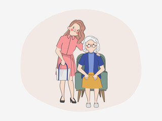 Smiling woman with happy elderly woman in nursing home.