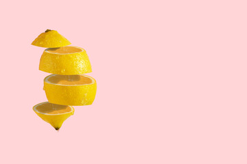 Lemon sliced on pastel  pink background. Minimal trendy fruit concept.