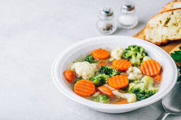 Vegetable soup. Spring broccoli, cauliflower, carrots soup in bowl.