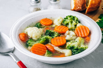 Vegetable soup. Spring broccoli, cauliflower, carrots soup in bowl.