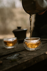 Traditional Chinese tea ceremony in the forest. Calming drink and nature. Relaxation in woods.