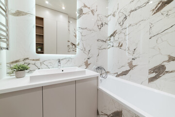 new clean bright bathroom with mirror in the interior of the house