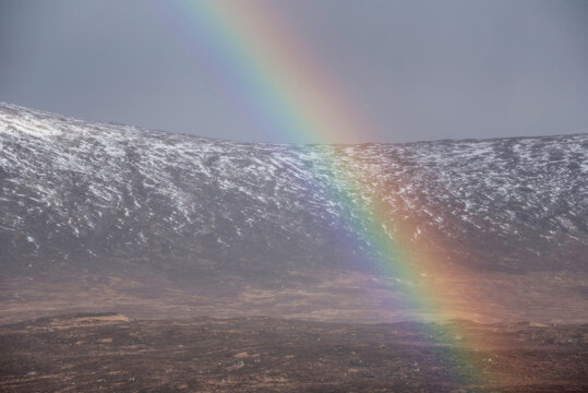 Beautiful landscape image of vibrant rainbow in front of mountains in Scottish Highlands Rannoch Moor Stob Dearg