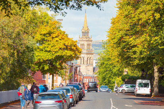 Elmwood Presbyterian Church in Belfast - Cars parked on a street and people walking - Northern Ireland