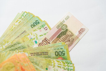 russian ruble peeking through a range of Argentine pesos